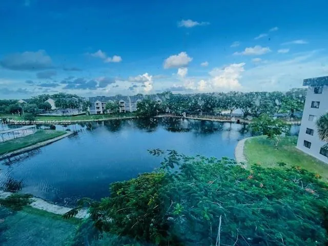 an aerial view of a house with a yard and lake view