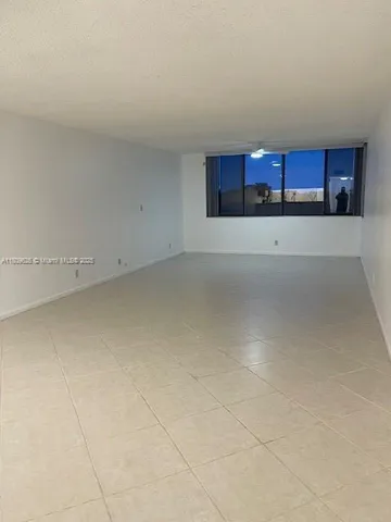 a view of a kitchen with stainless steel appliances granite countertop a sink and cabinets