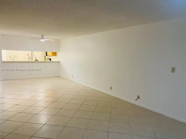 a view of a refrigerator and window in a room