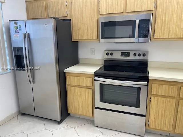 a kitchen with a stove microwave and refrigerator