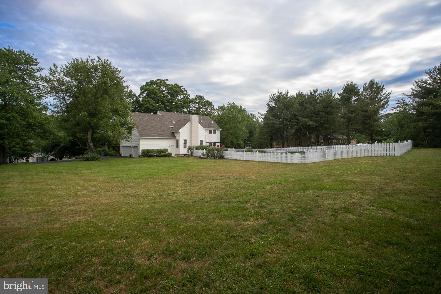 215 Yorkshire Terrace Wrightstown, NJ 08562 - Photo 40 of 43 a view of a white house with a yard and sitting area