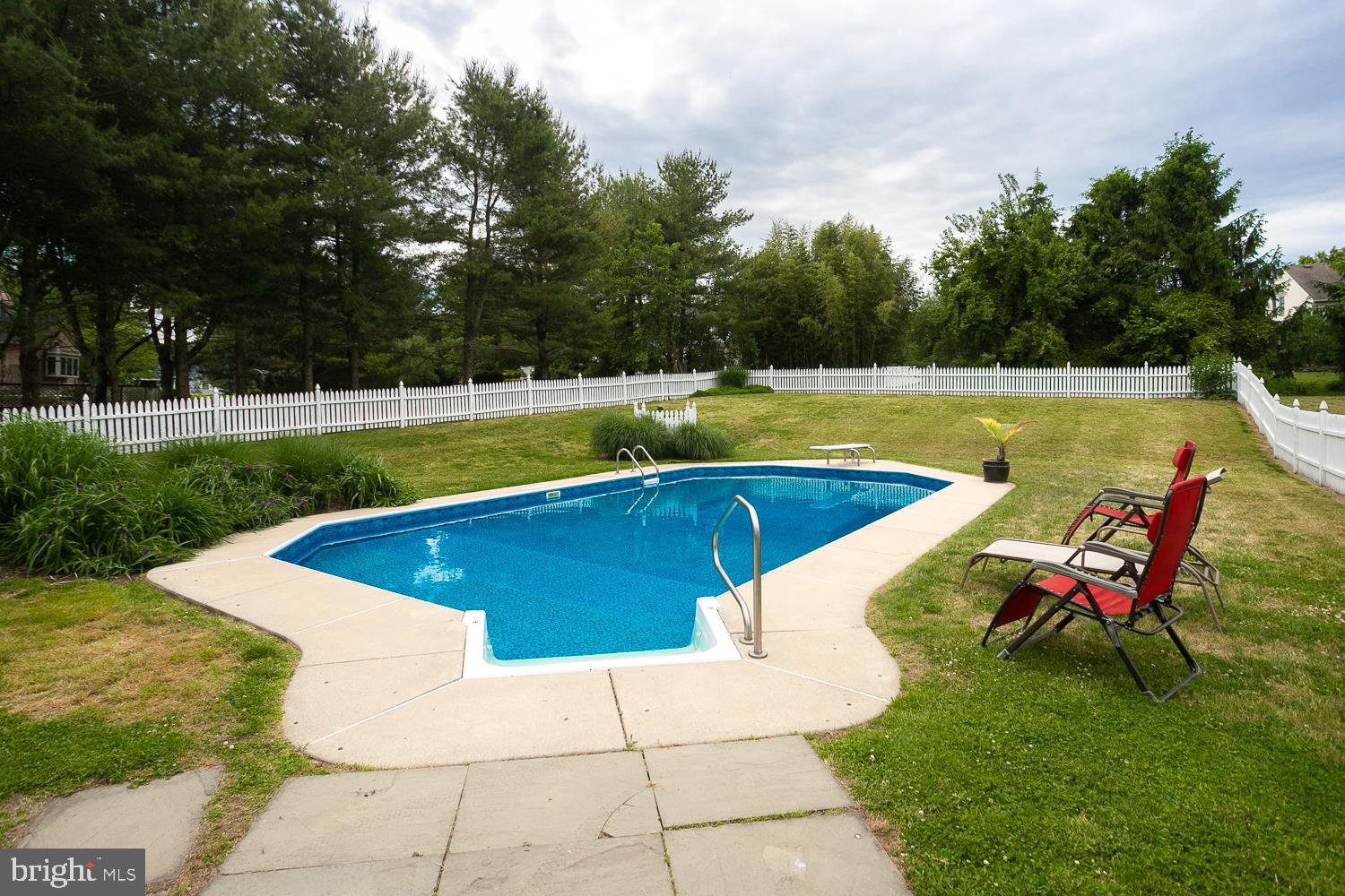 215 Yorkshire Terrace Wrightstown, NJ 08562 - Photo 42 of 43 a view of a swimming pool with a lounge chair