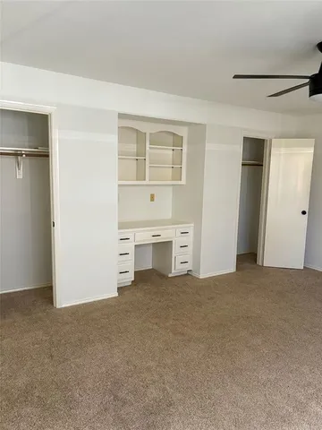 a view of an empty room with closet area