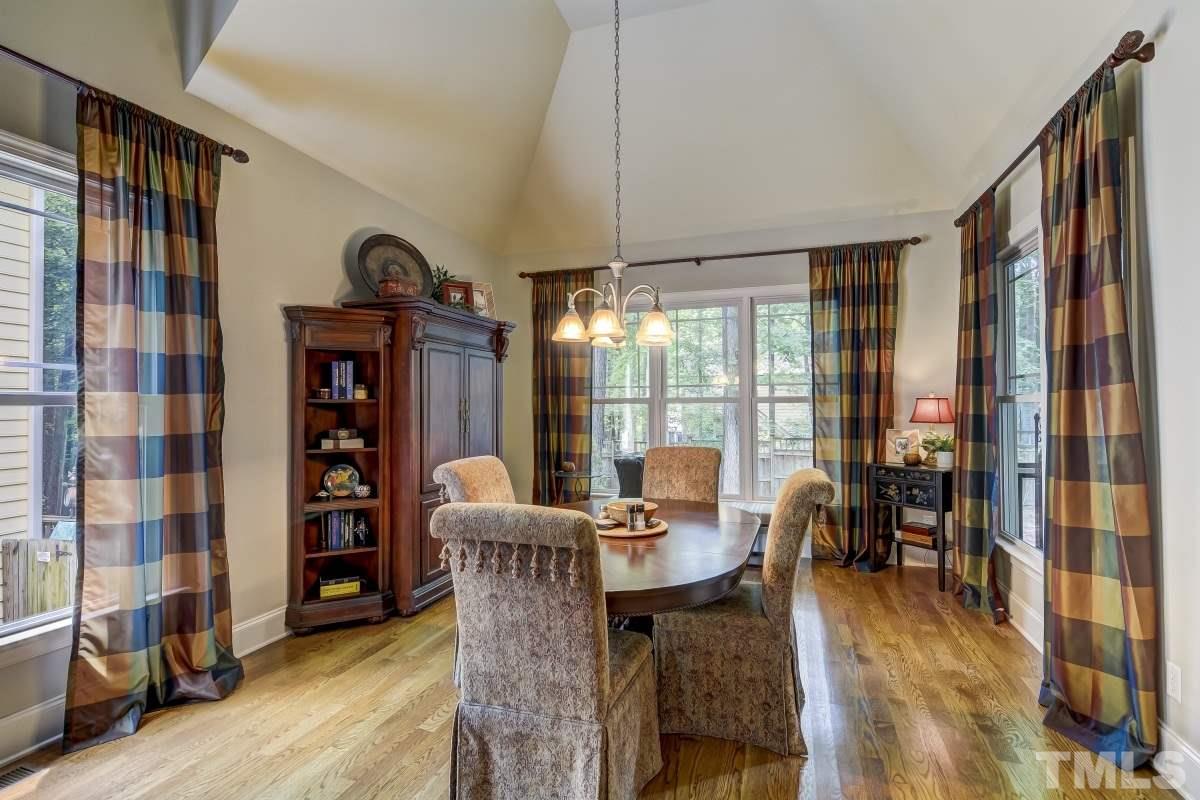 7207 Newport Avenue Raleigh, NC 27613 - Photo 11 of 25 a view of a dining room with furniture window and wooden floor