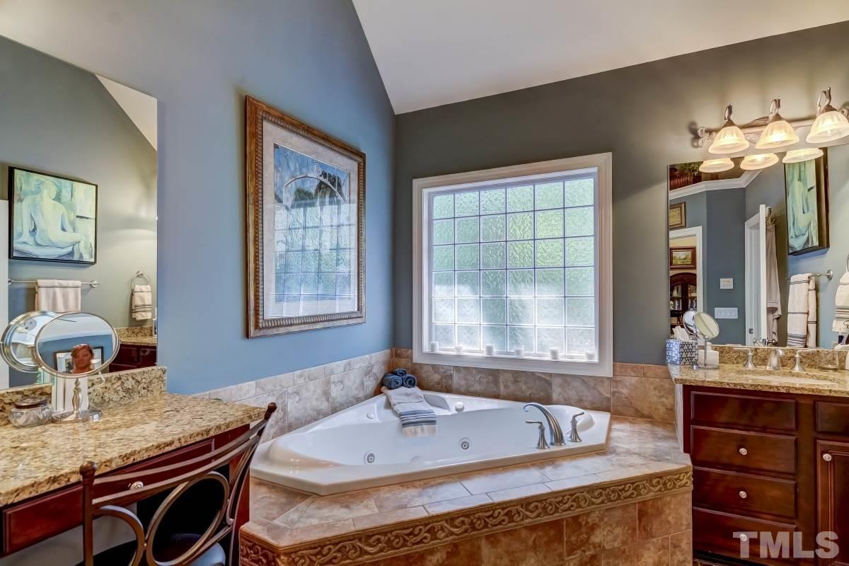 7207 Newport Avenue Raleigh, NC 27613 - Photo 14 of 25 a bath tub sitting next to a bathroom sink