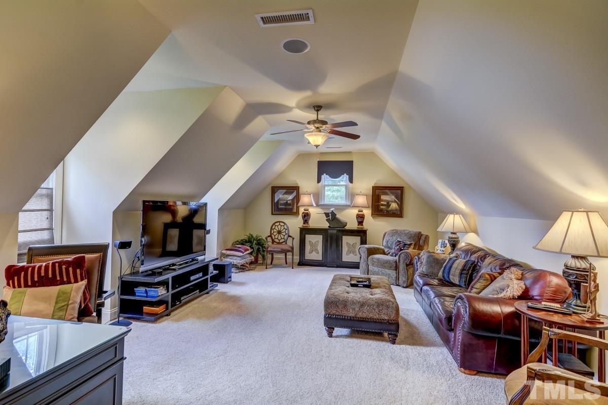 7207 Newport Avenue Raleigh, NC 27613 - Photo 19 of 25 a living room with lots of furniture and a flat screen tv
