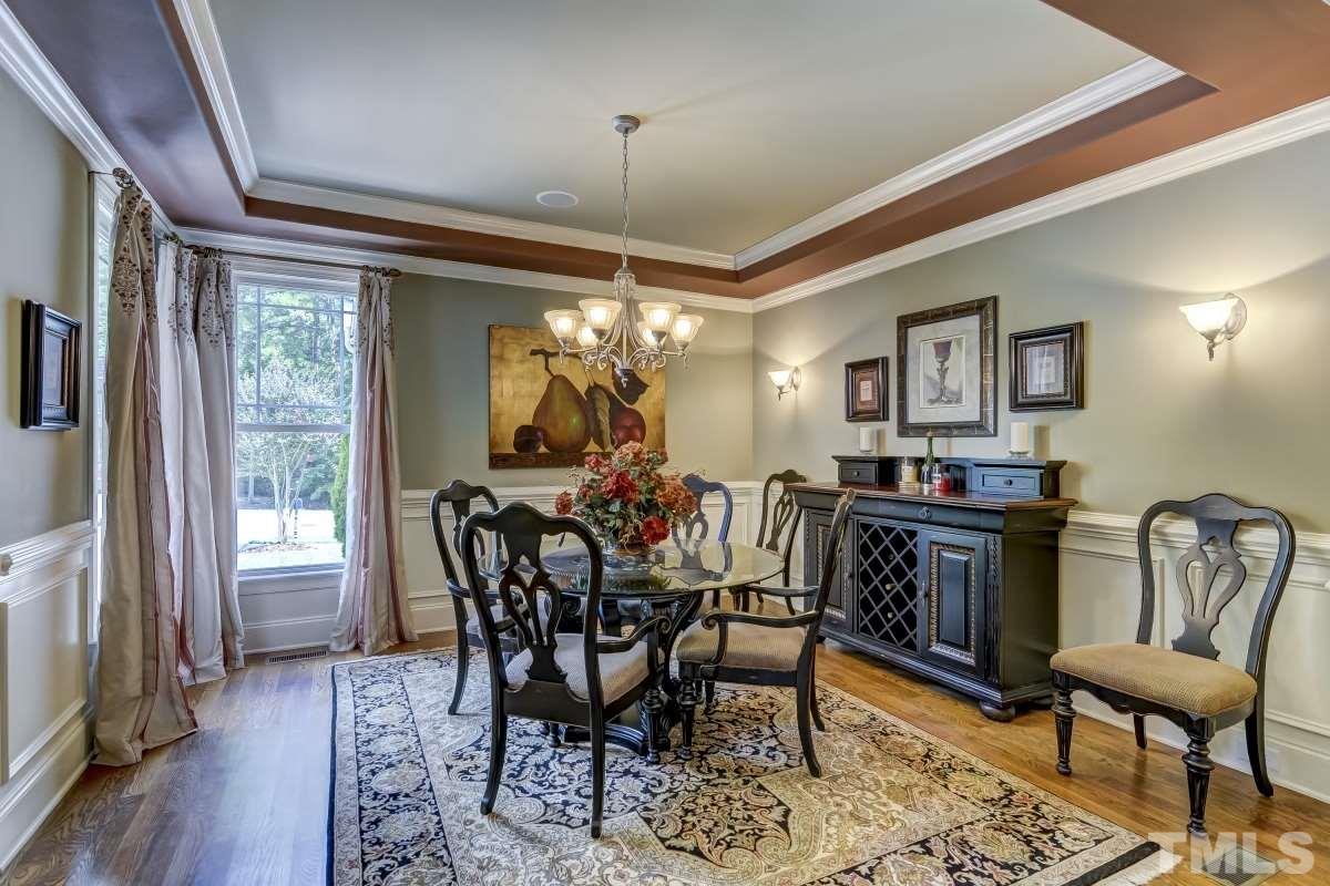 7207 Newport Avenue Raleigh, NC 27613 - Photo 3 of 25 a view of a dining room with furniture window and wooden floor