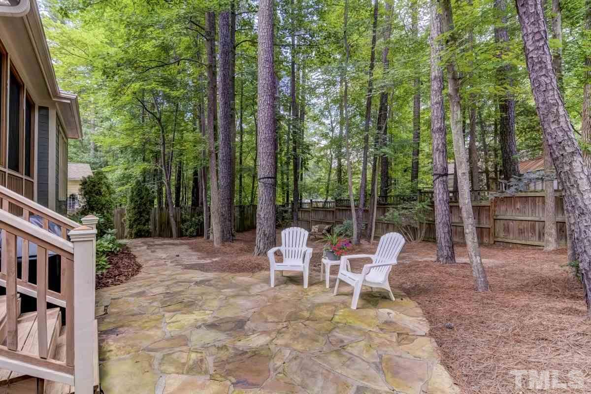 7207 Newport Avenue Raleigh, NC 27613 - Photo 25 of 25 a view of backyard with table and chairs and large trees