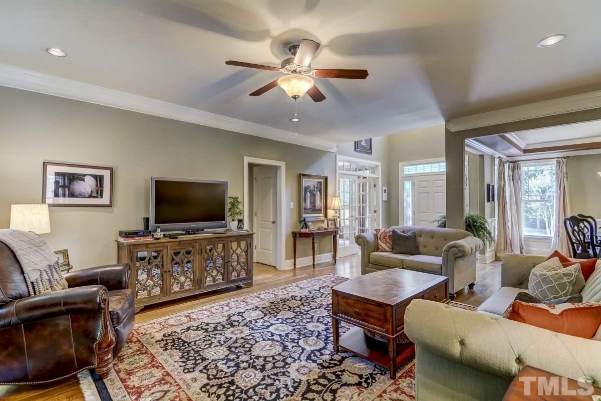 7207 Newport Avenue Raleigh, NC 27613 - Photo 5 of 25 a living room with furniture and a flat screen tv