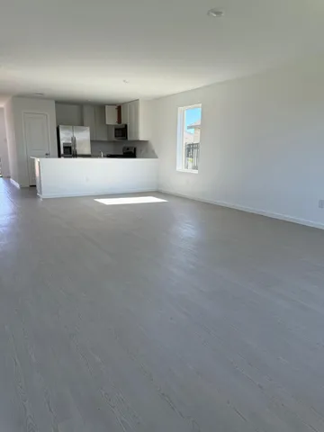 a large bedroom with a bed and window