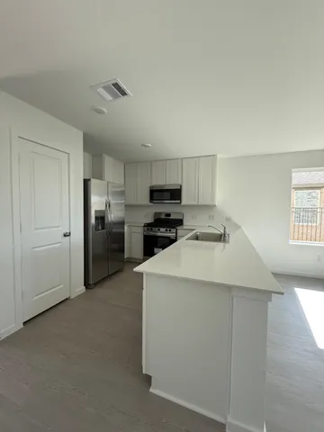 a kitchen with cabinets and stainless steel appliances