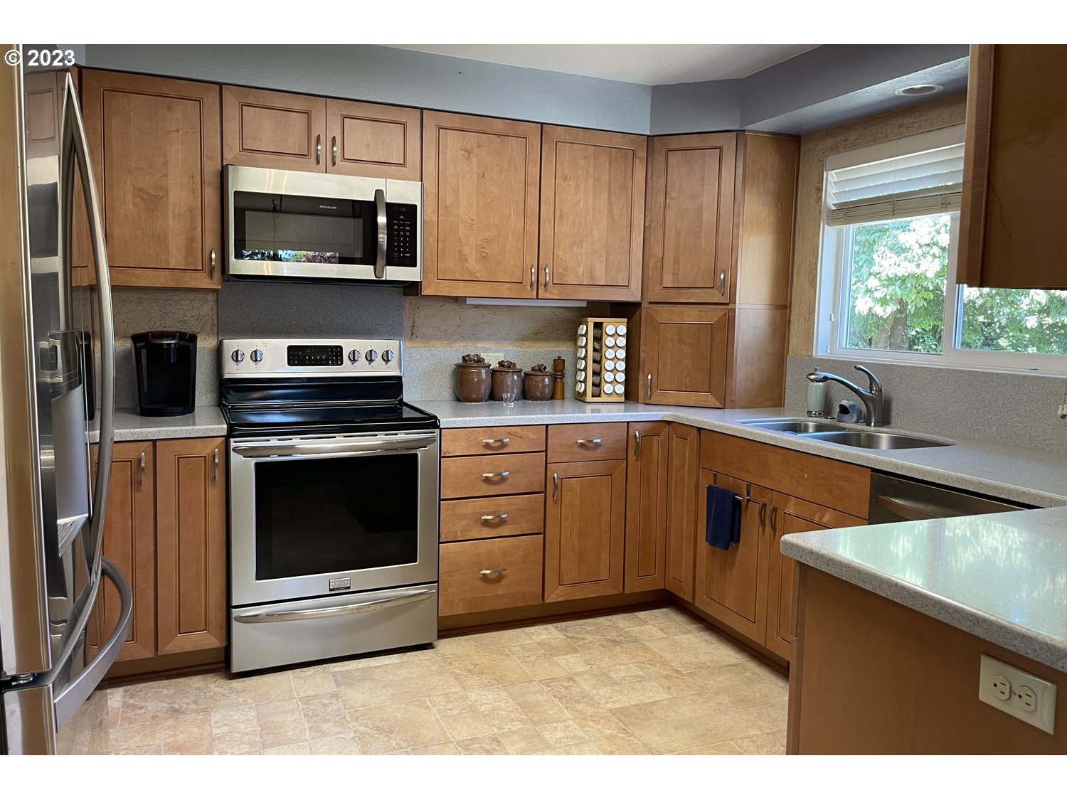 1155 Diamond Street Springfield, OR 97477 - Photo 7 of 34 a kitchen with stainless steel appliances a stove microwave and sink