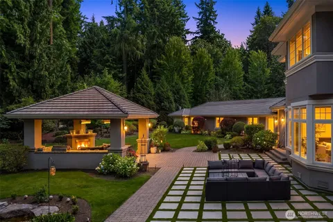 a view of a house with backyard porch and sitting area