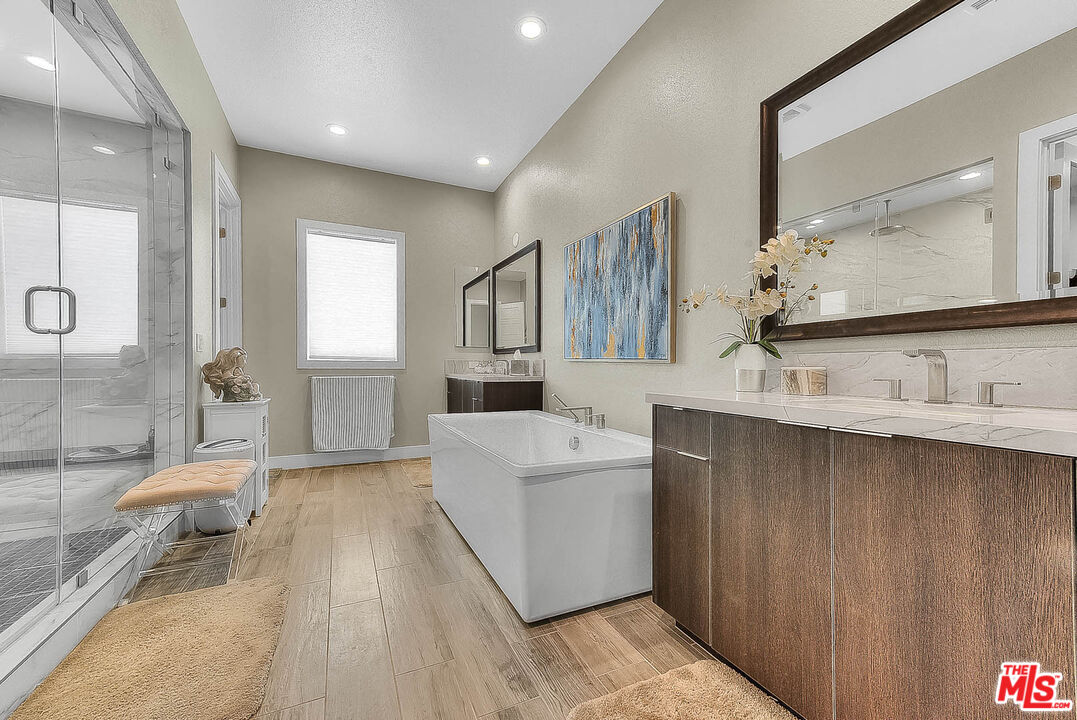 20558 Overlook Court Porter Ranch, CA 91326 - Photo 23 of 48 a spacious bathroom with a double vanity sink a mirror and a shower
