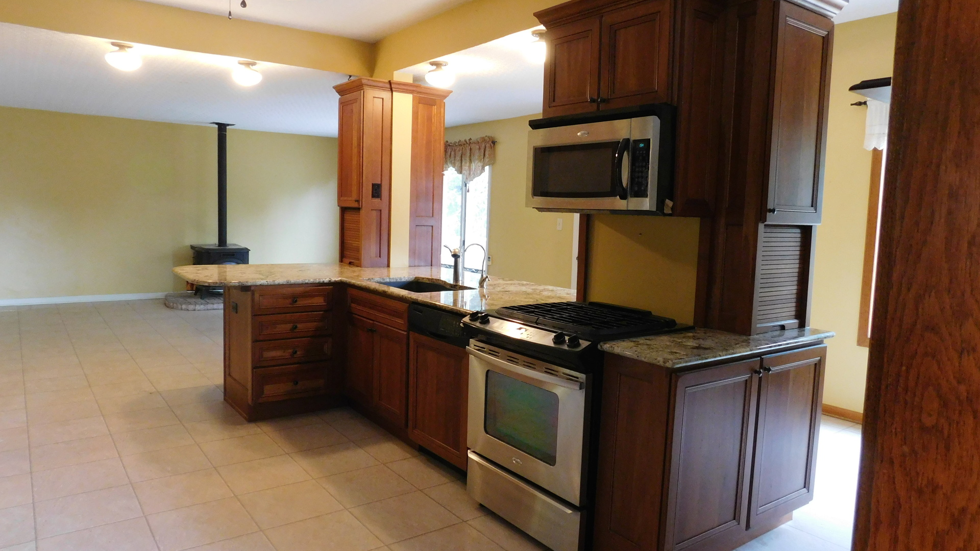 1232 B Steward Road Steward, IL 60553 - Photo 17 of 44 a kitchen with stainless steel appliances granite countertop a stove and a microwave