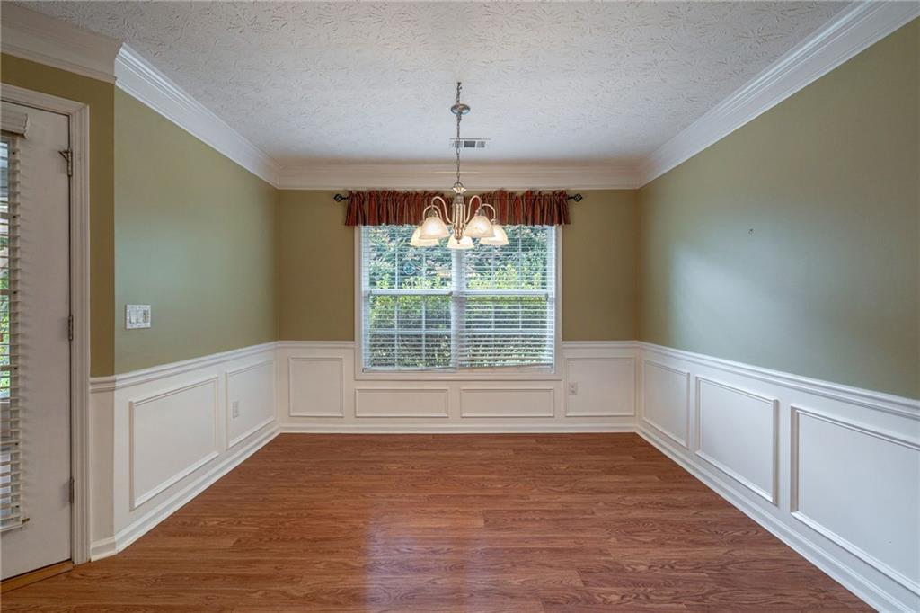 245 Memory Lane Winder, GA 30680 - Photo 21 of 62 a view of an empty room with wooden floor and a window