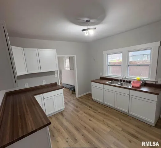 a kitchen with granite countertop white cabinets and white appliances