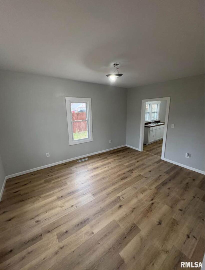 618 South McLeansboro Road Benton, IL 62812 - Photo 10 of 17 a view of a big room with wooden floor and windows