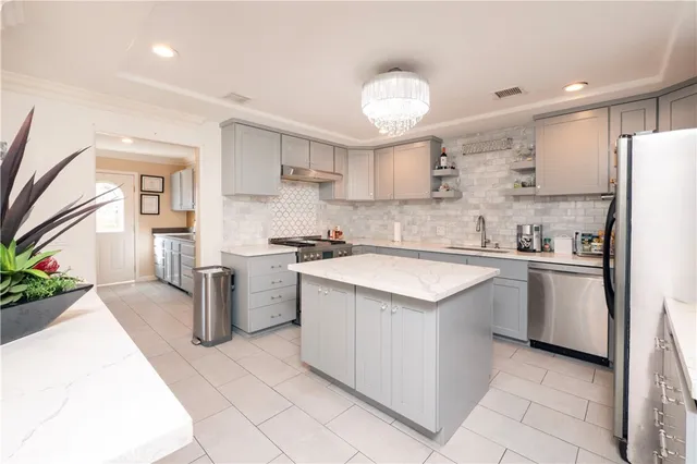 a kitchen with a stove sink and cabinets