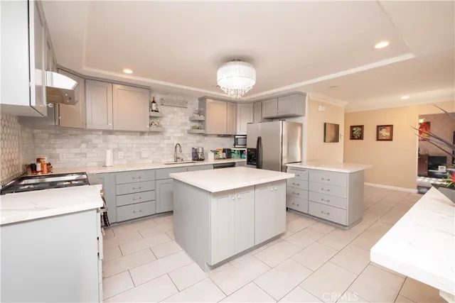a kitchen with cabinets appliances a sink and a counter space