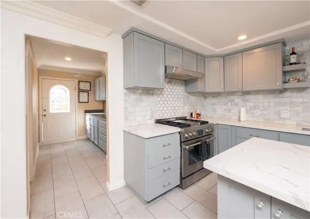 a kitchen with a refrigerator and cabinets