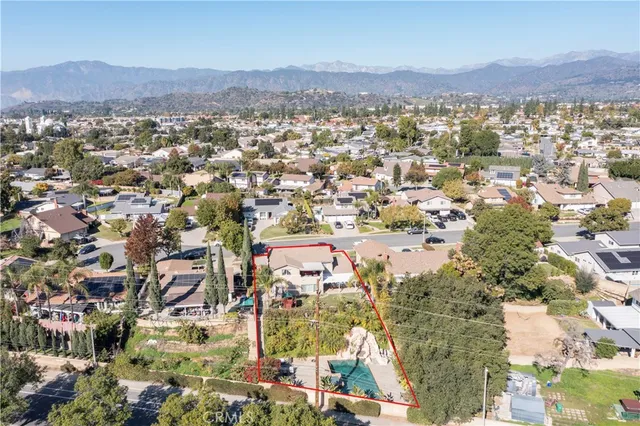 an aerial view of a house with a yard and garden
