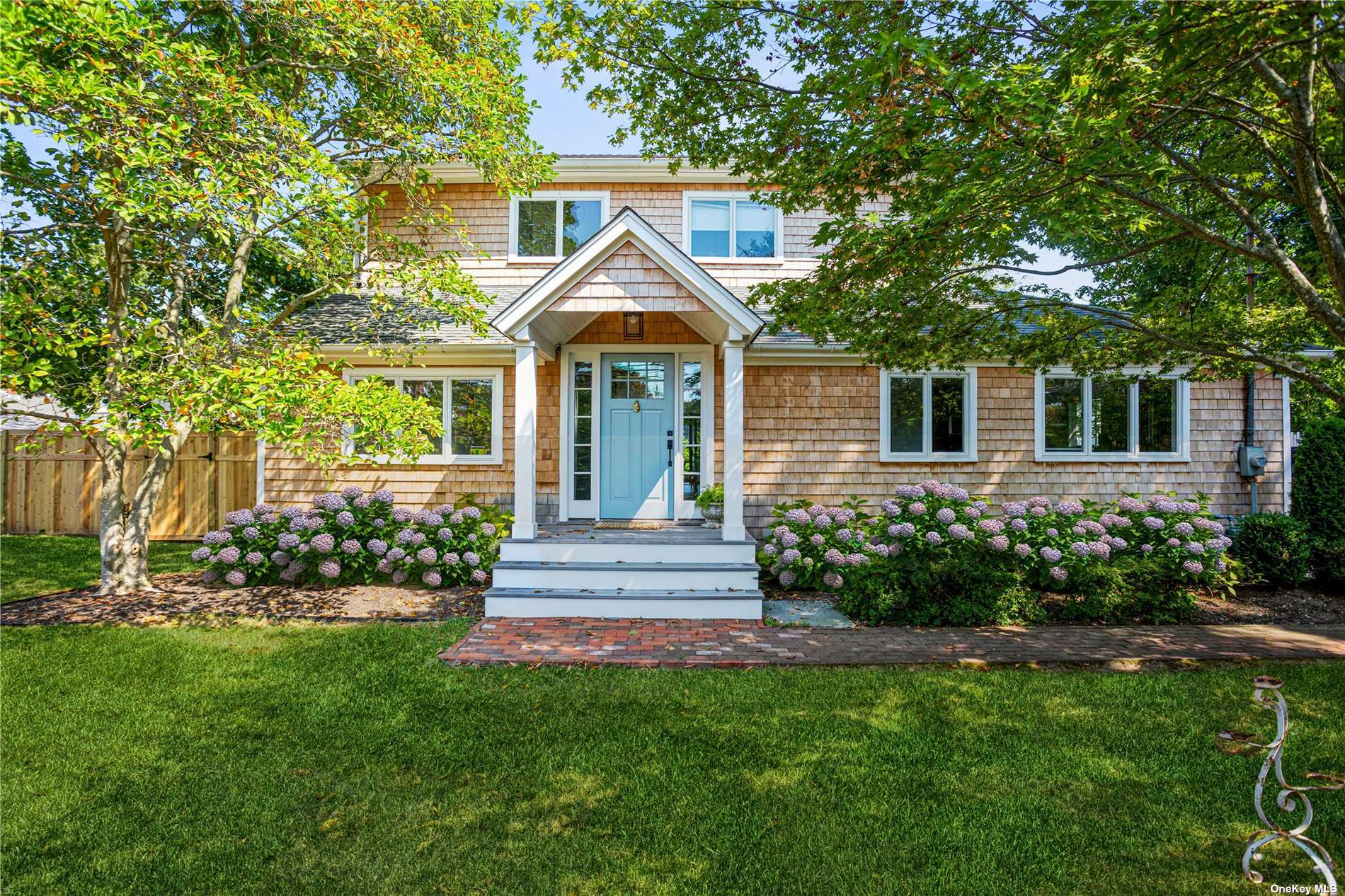 a front view of a house with a garden