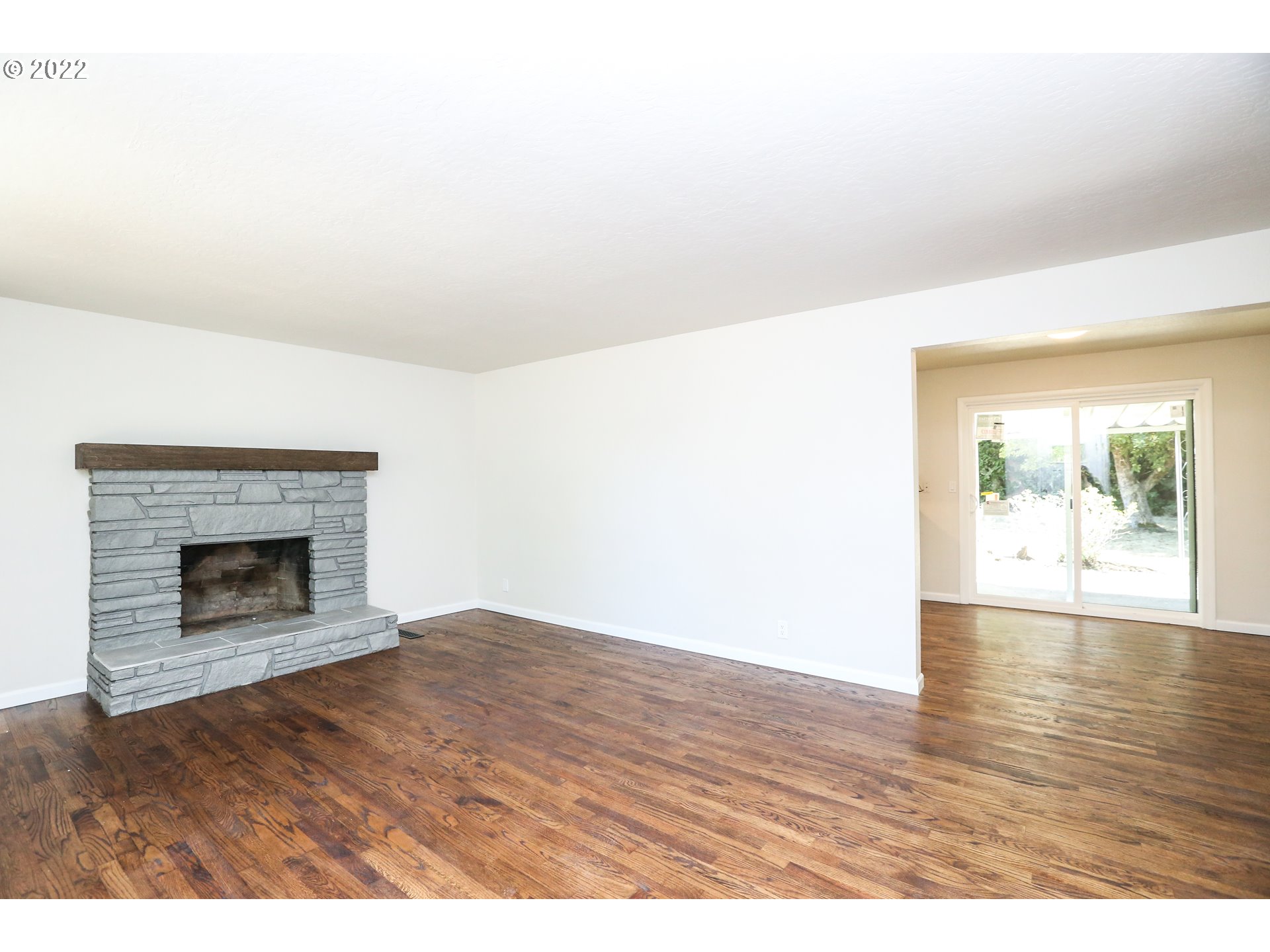 2884 Manor Drive Springfield, OR 97477 - Photo 3 of 17 a view of an empty room with wooden floor and a fireplace