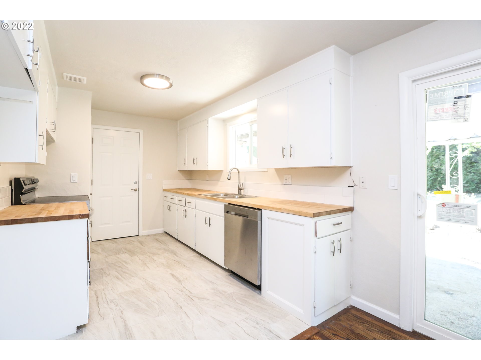 2884 Manor Drive Springfield, OR 97477 - Photo 6 of 17 a kitchen with a sink cabinets stainless steel appliances and a window