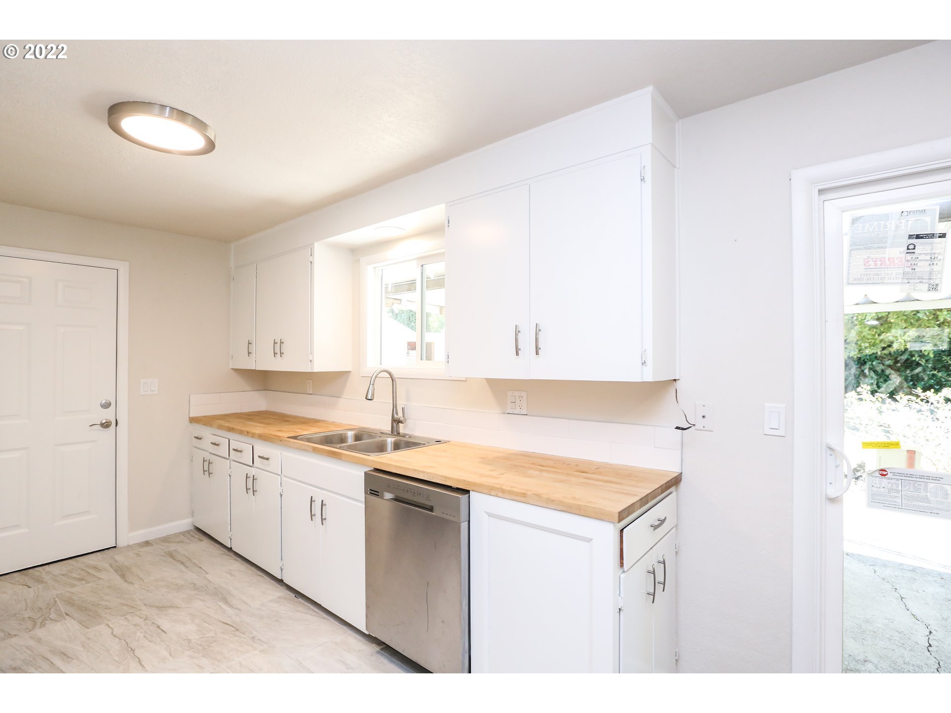 2884 Manor Drive Springfield, OR 97477 - Photo 7 of 17 a kitchen with a sink cabinets and window