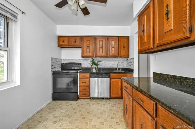 a kitchen with stainless steel appliances granite countertop a stove sink and cabinets