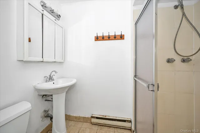 a bathroom with a sink a toilet and a mirror