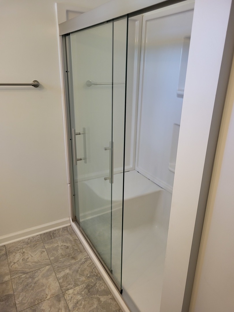 4509 Island Road Harvard, IL 60033 - Photo 16 of 40 a bathroom with a glass shower door