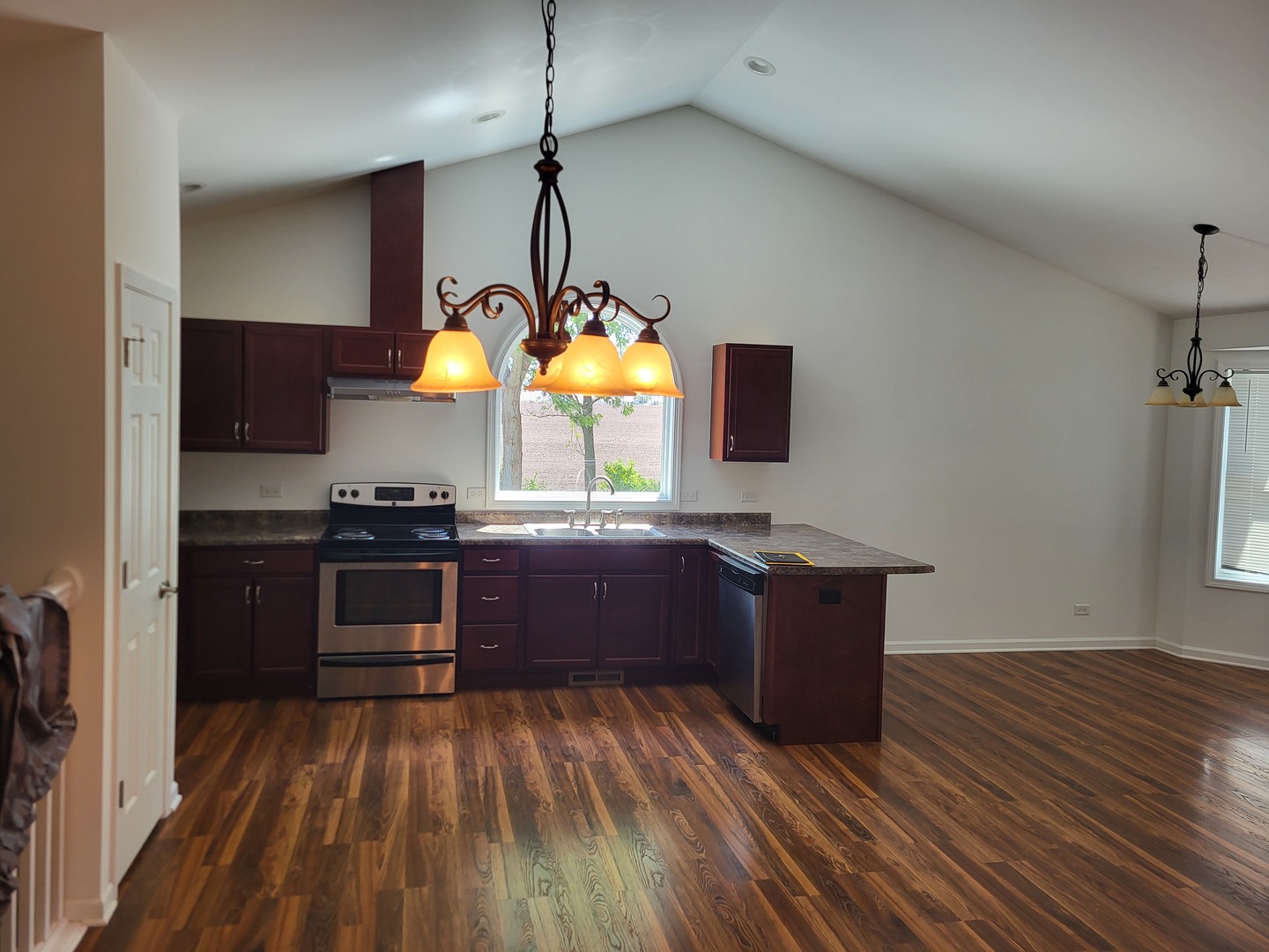 4509 Island Road Harvard, IL 60033 - Photo 9 of 40 a kitchen with stainless steel appliances granite countertop a stove and a wooden floors