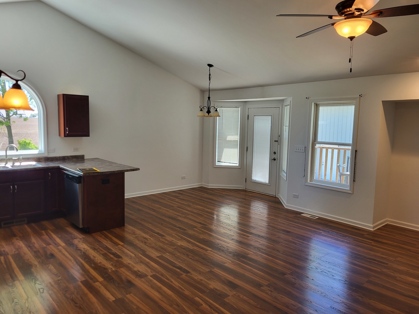 4509 Island Road Harvard, IL 60033 - Photo 10 of 40 a kitchen with granite countertop a stove and a wooden floor