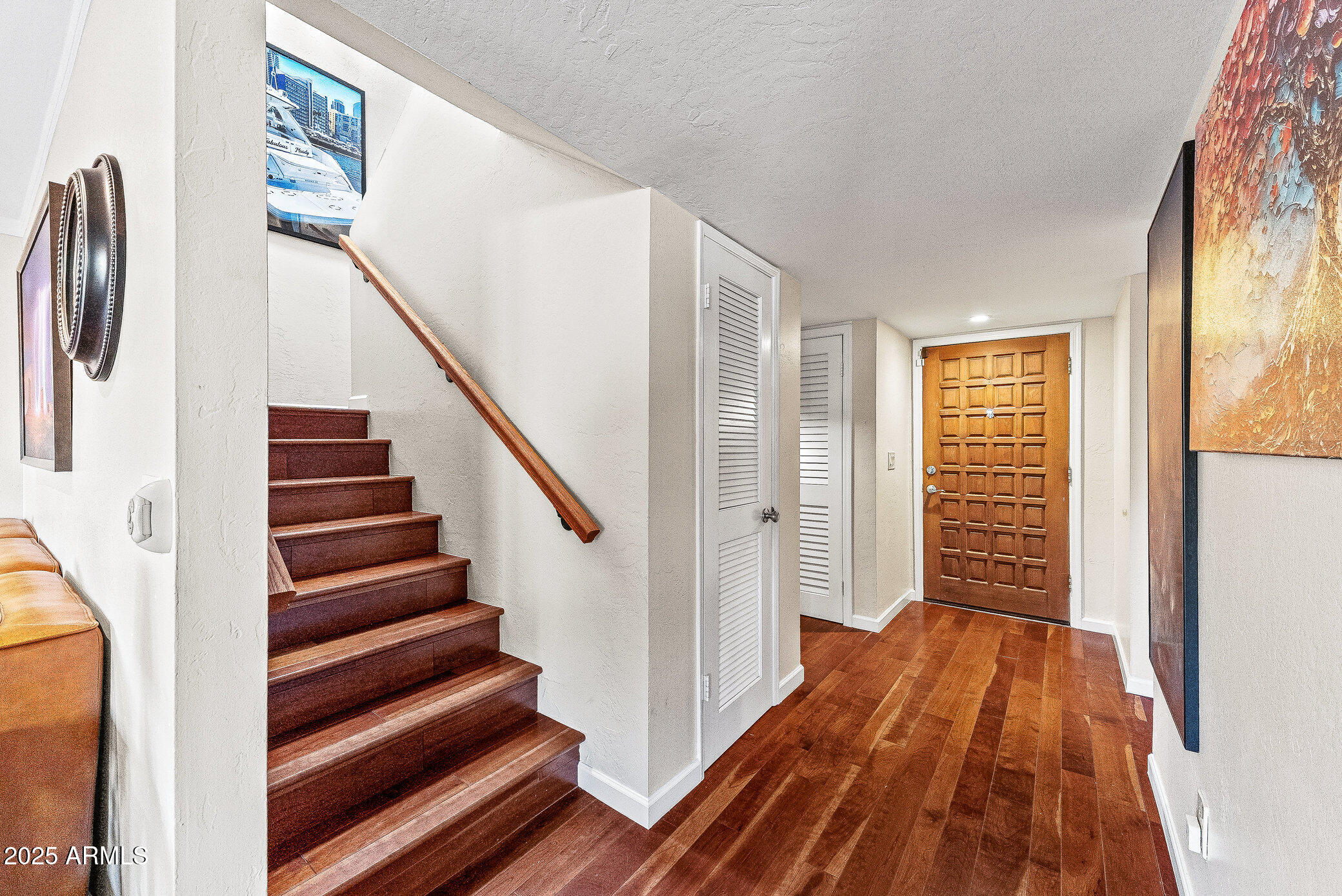 6159 East Indian School Road, Unit 104 Scottsdale, AZ 85251 - Photo 11 of 24 a view of a hallway with wooden floor and staircase