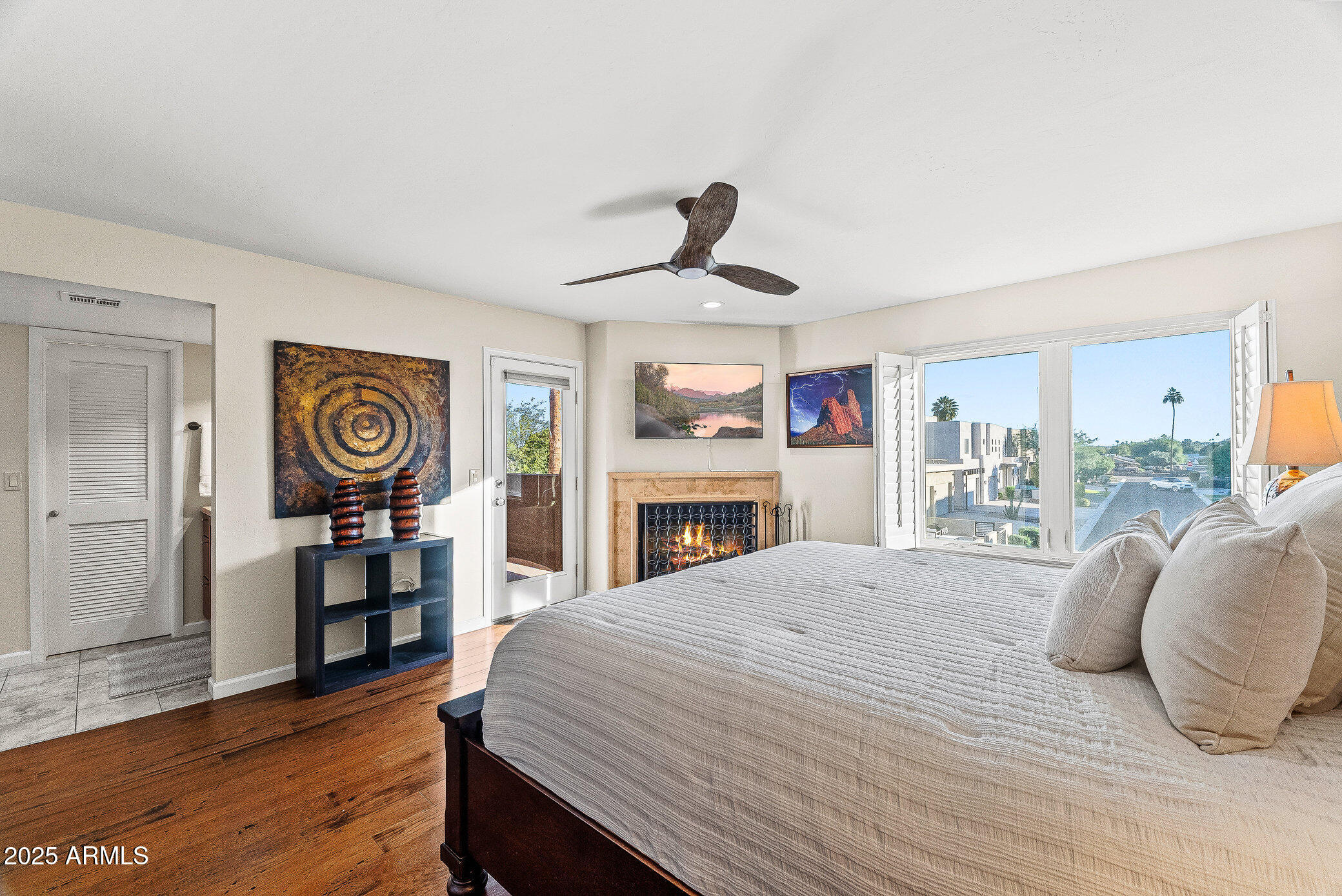 6159 East Indian School Road, Unit 104 Scottsdale, AZ 85251 - Photo 15 of 24 a bedroom with a bed and wooden floor