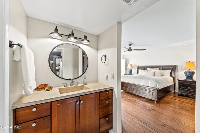 a en suite bathroom with a double vanity sink and a mirror