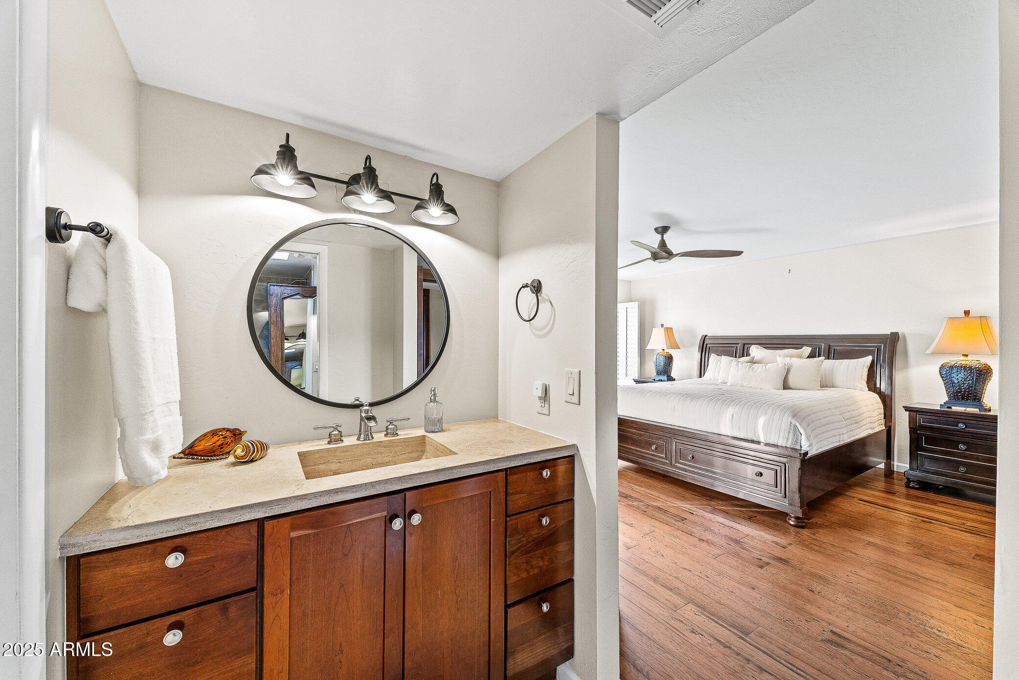 6159 East Indian School Road, Unit 104 Scottsdale, AZ 85251 - Photo 17 of 24 a en suite bathroom with a double vanity sink and a mirror