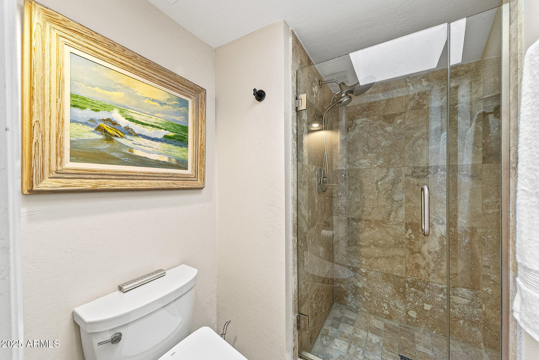 6159 East Indian School Road, Unit 104 Scottsdale, AZ 85251 - Photo 18 of 24 a white toilet sitting next to a bathroom shower