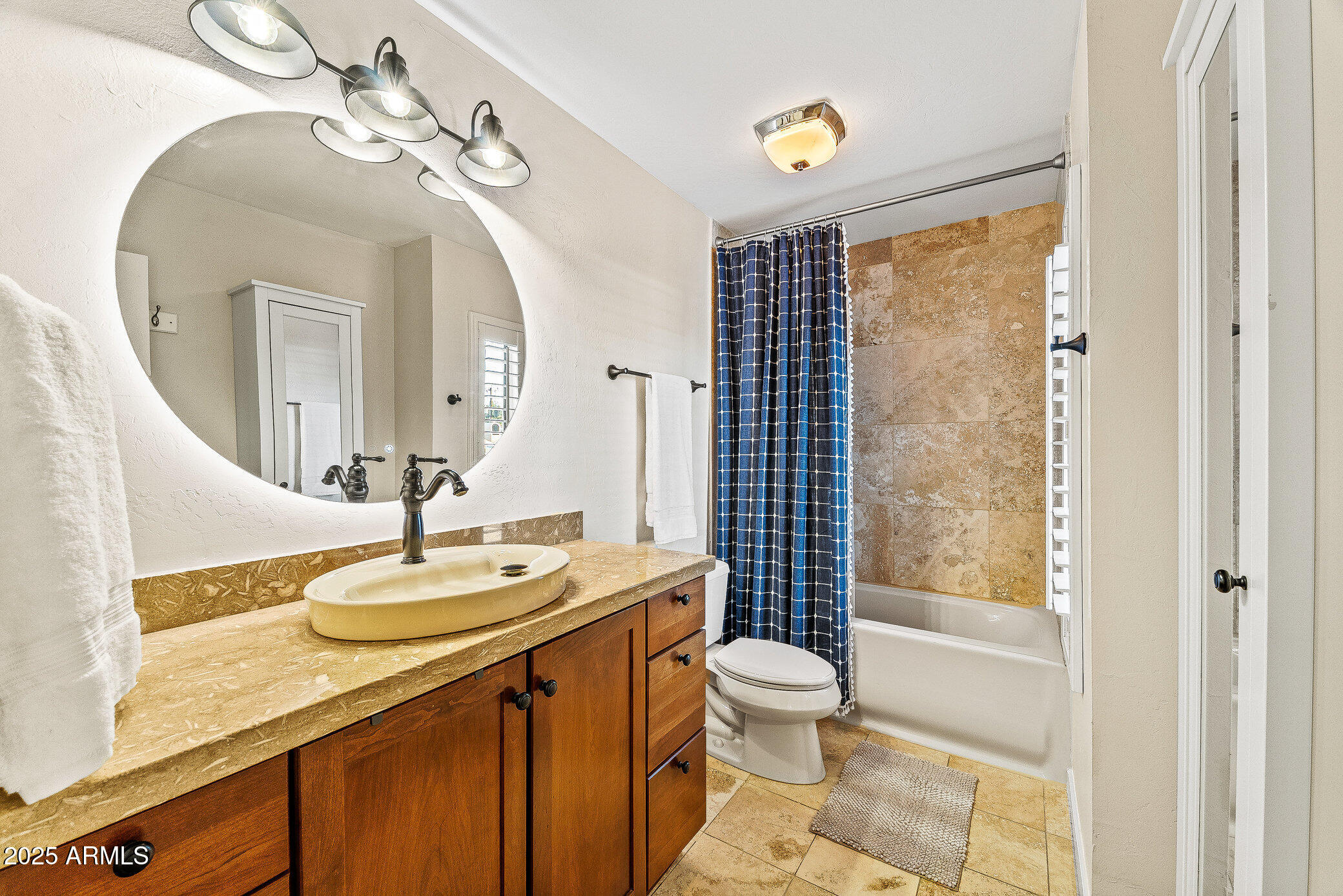 6159 East Indian School Road, Unit 104 Scottsdale, AZ 85251 - Photo 22 of 24 a bathroom with a sink a toilet and shower