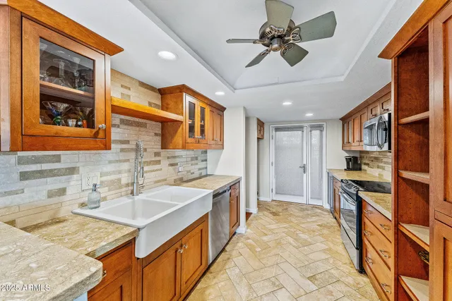 a spacious bathroom with a granite countertop sink a mirror and shower
