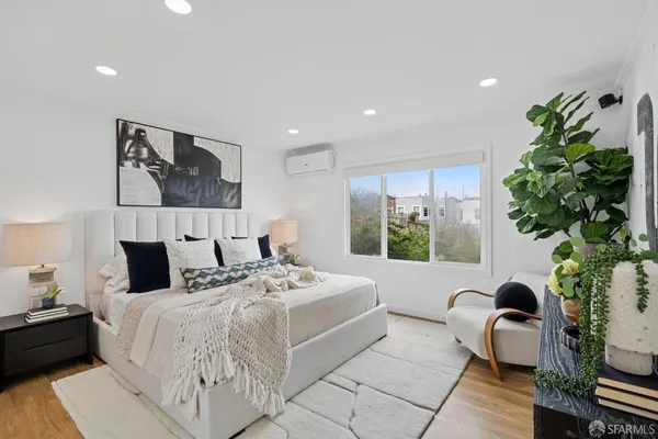 a bedroom with a bed and a painting on the wall