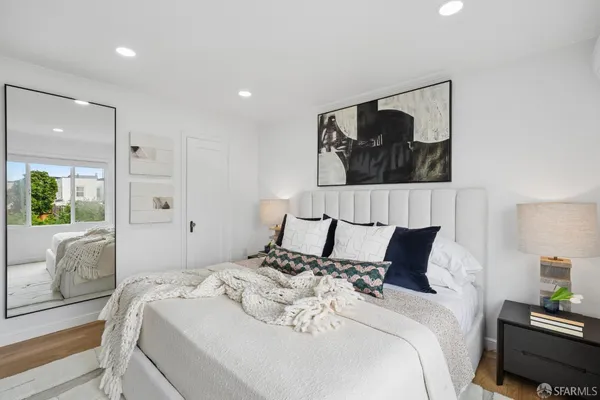 a bedroom with bed and a large window