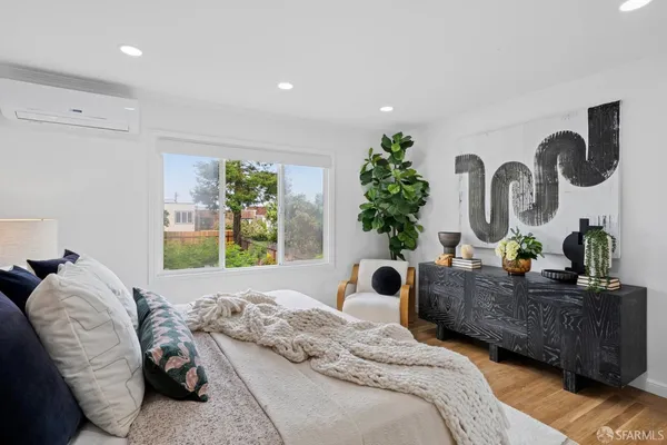 a bedroom with furniture and a potted plant