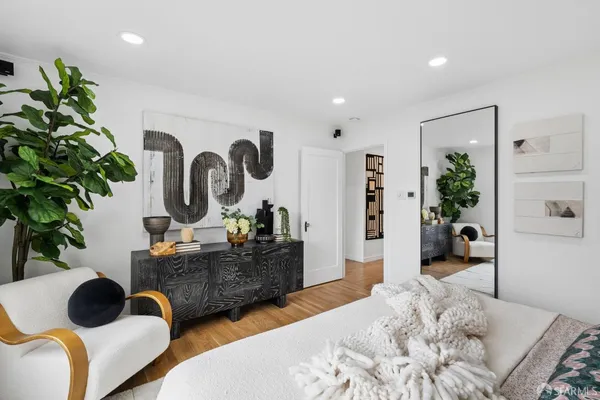 a living room with furniture and a potted plant