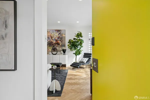 a living room with furniture a fireplace and a floor to ceiling window