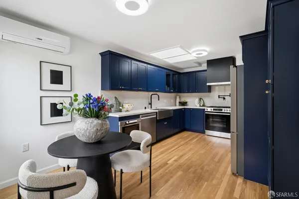 a kitchen with a sink a stove and cabinets