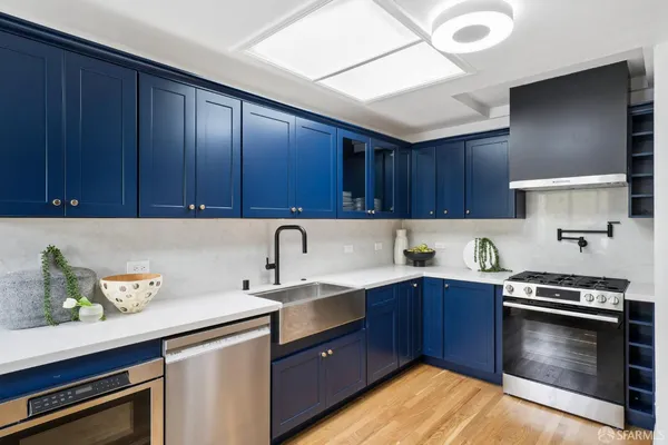 a kitchen with stainless steel appliances granite countertop a refrigerator and a stove top oven