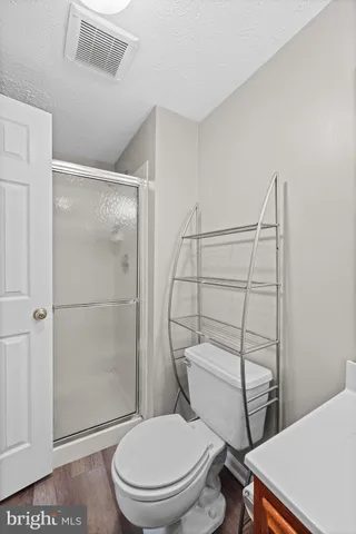 a white toilet sitting next to a bathroom sink